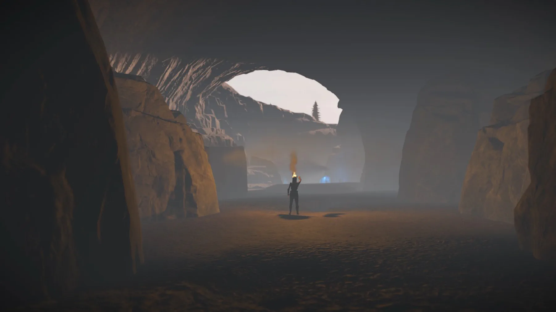 Expedition member with a torch in a deep cavern