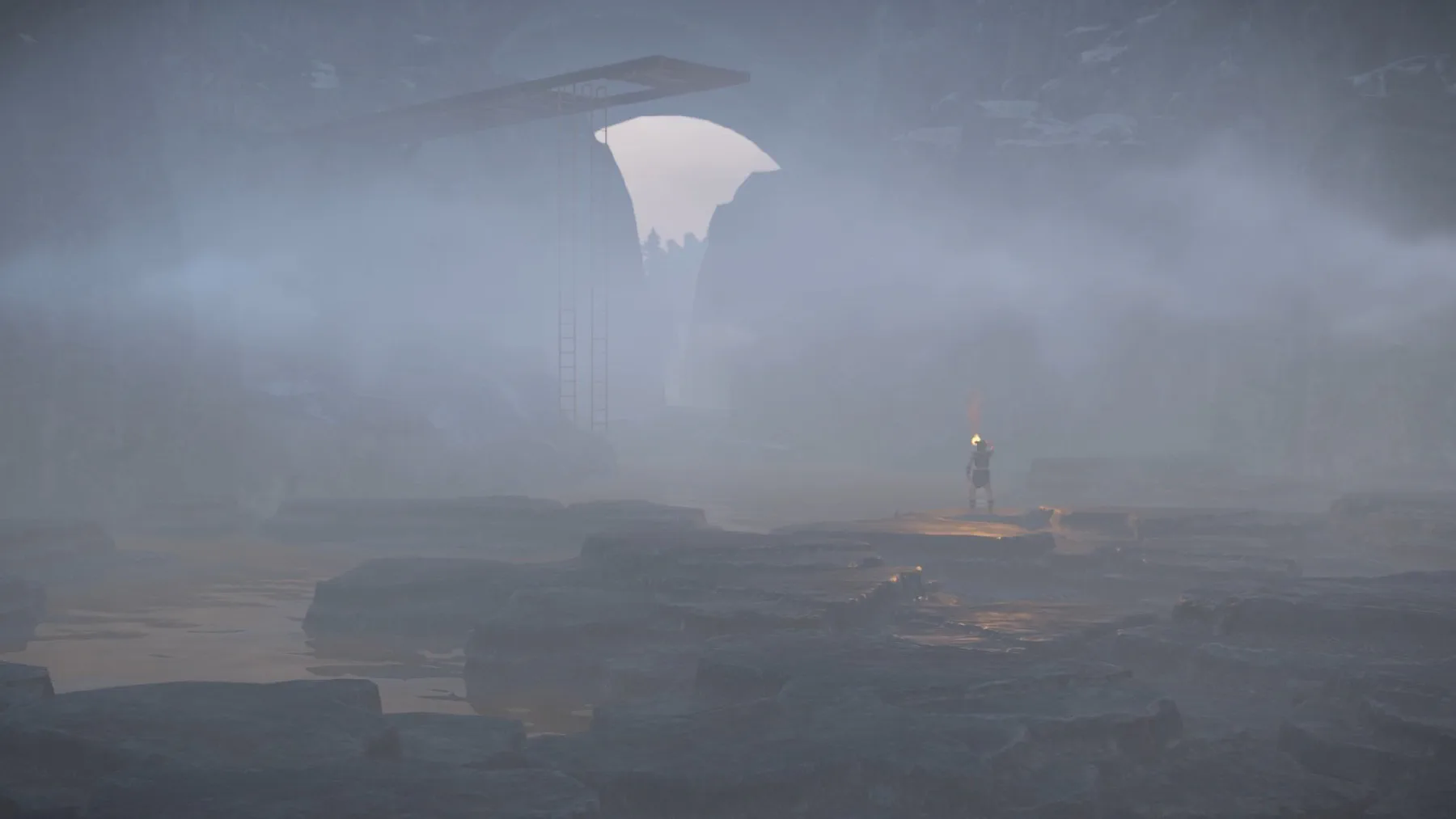 Expedition member carrying a torch inside a misty ravine