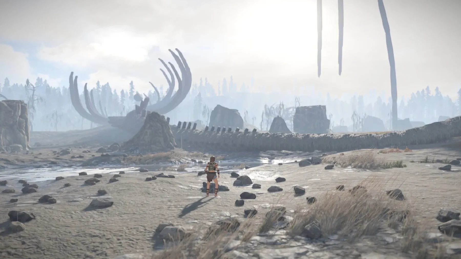 Expedition member standing beside an enormous dragon skeleton